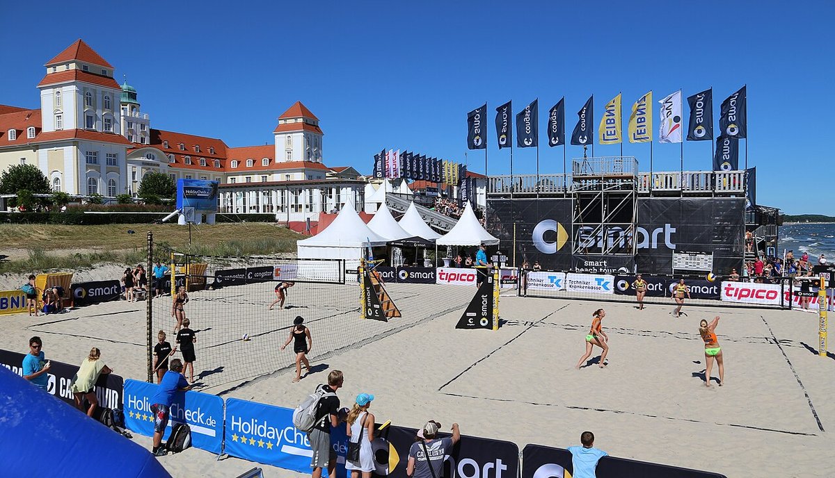 Beach volleyball tournament court in front of a seaside hotel