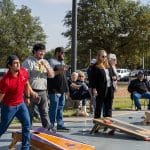 Cornhole player tossing a bag during a competition