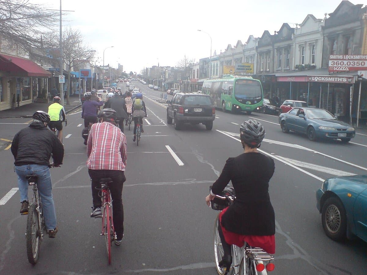 Group of friends cycling down a city street