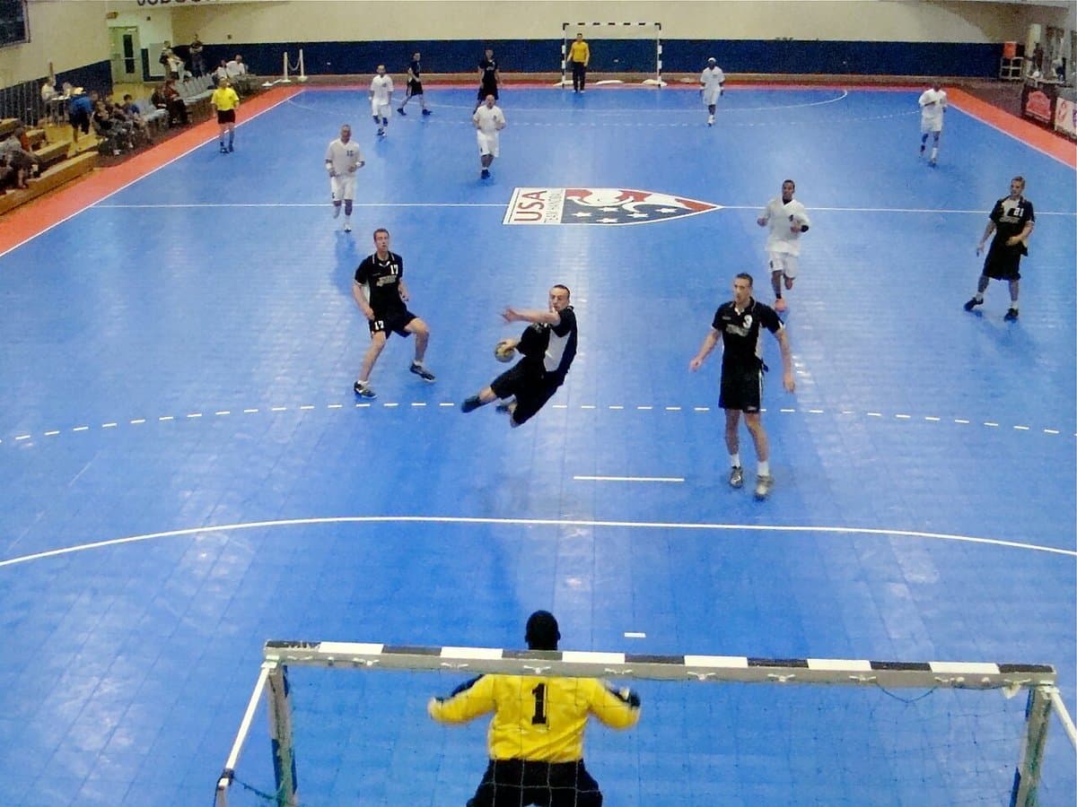 Handball player flying toward the goal for a jump shot