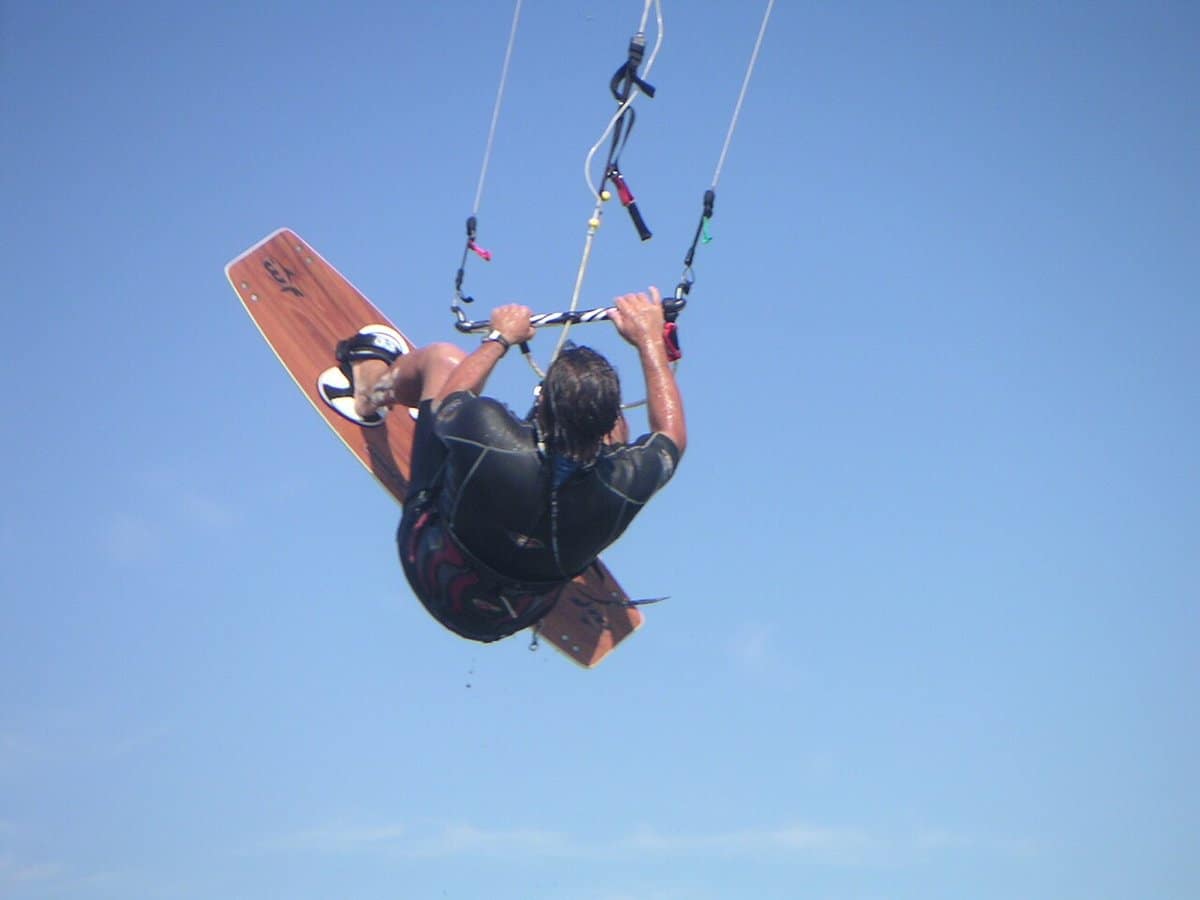 Kiteboarder flying high above the water during a jump