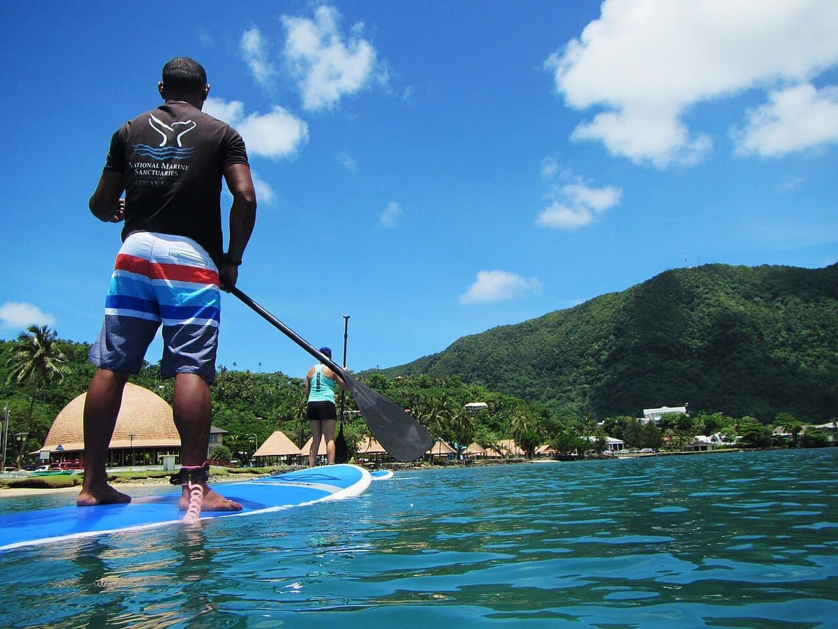 Paddler on a stand up paddleboard in clear tropical water