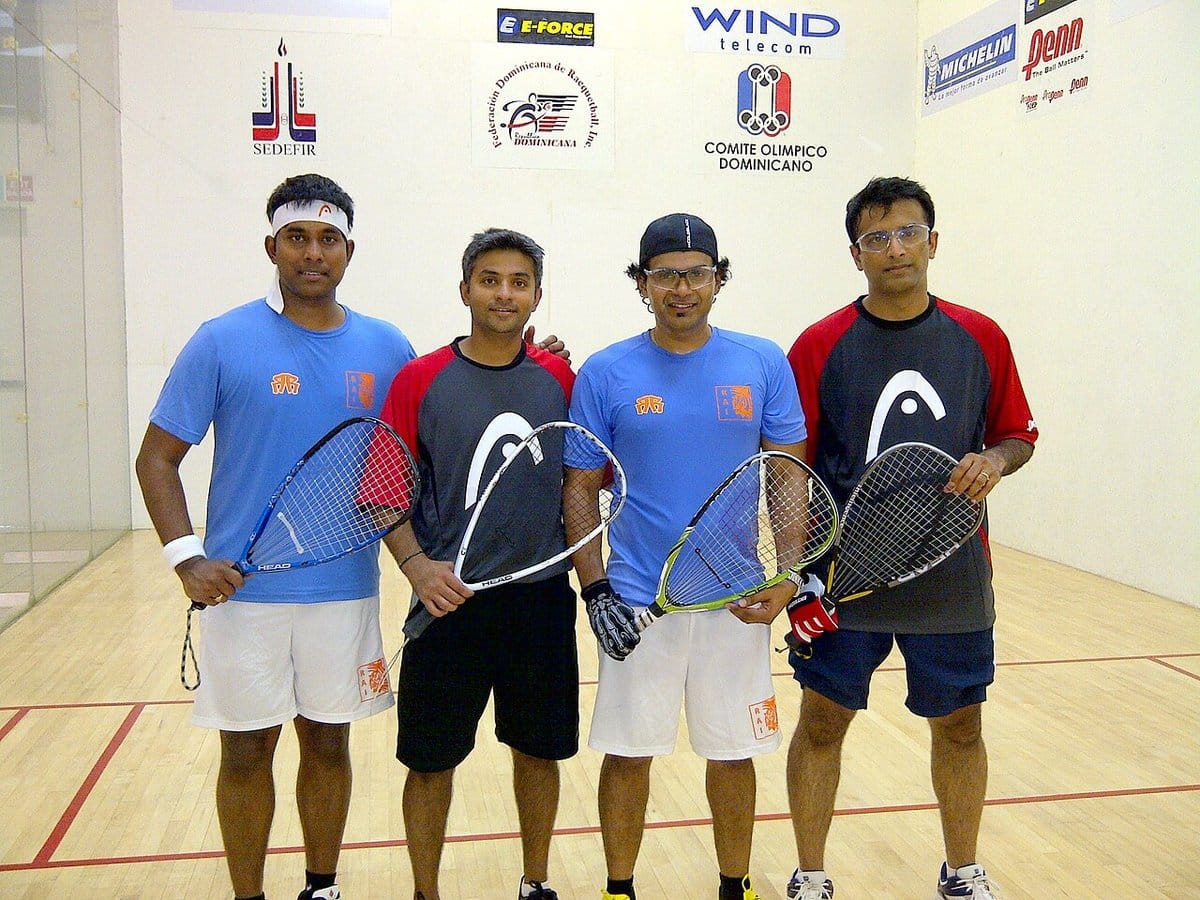 Racquetball players posing together on court
