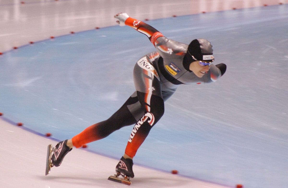 Long track speed skater pushing hard through the straight