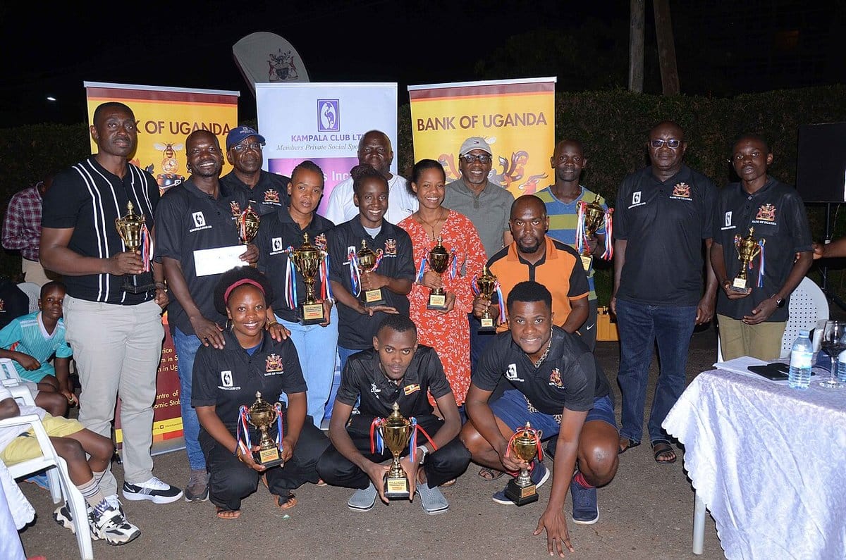 Squash players posing with trophies after a local tournament