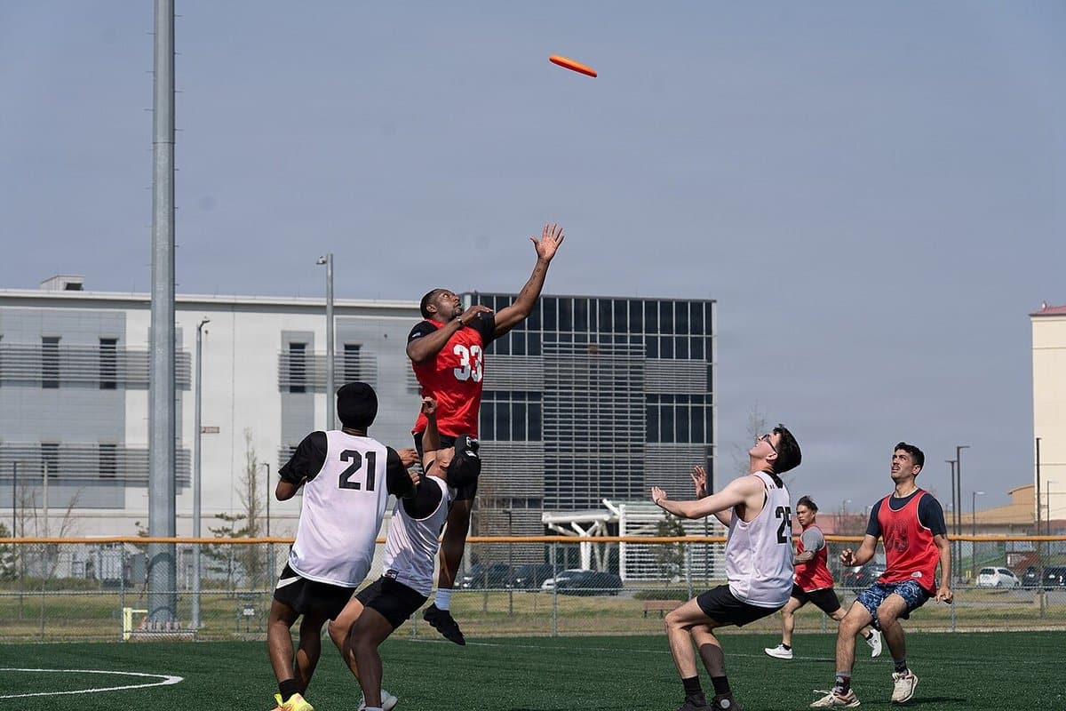 Players jumping for a pull during an ultimate frisbee match