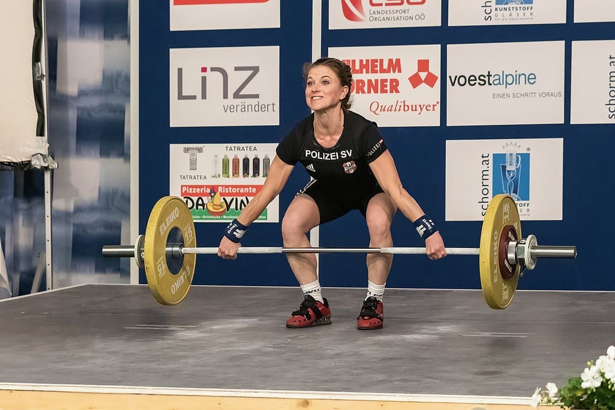 Woman setting up for a snatch on the competition platform