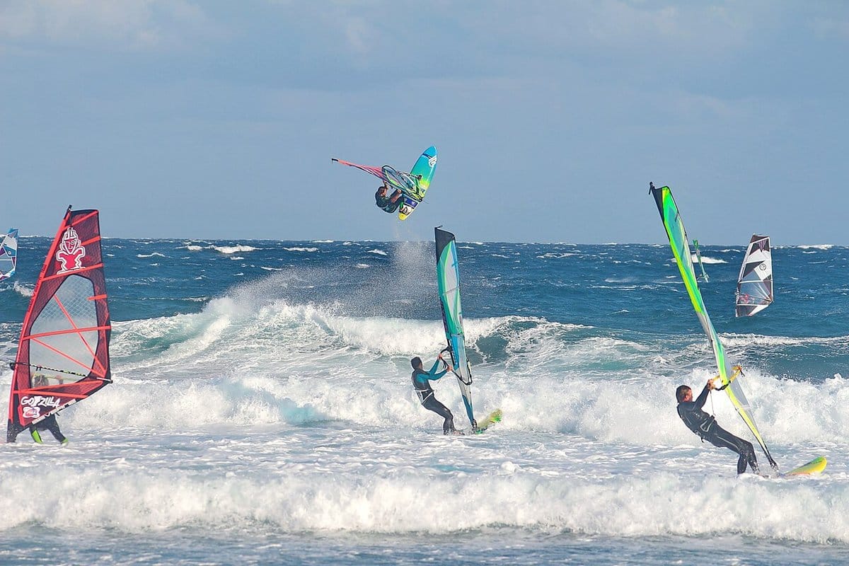 Windsurfers jumping off the breaking waves