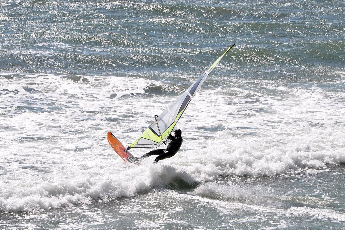 Windsurfer ripping across whitecaps on a stormy day